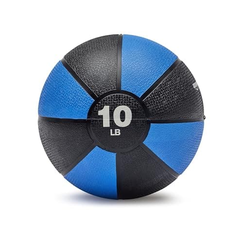 A man in a gym performing a workout with a green medicine ball