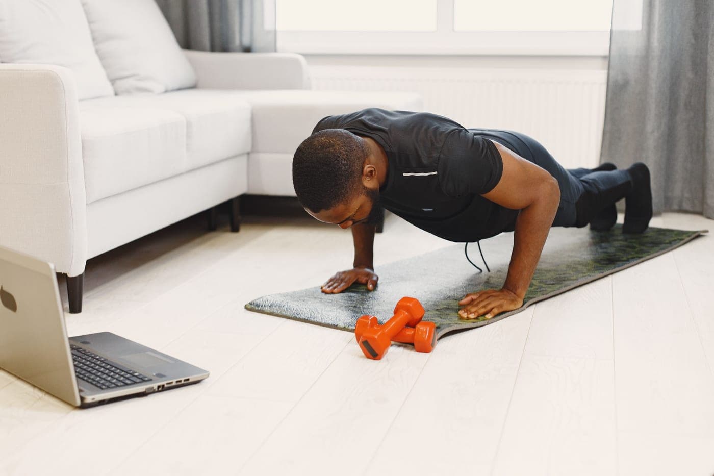 A person training with bodyweight exercises in a home space