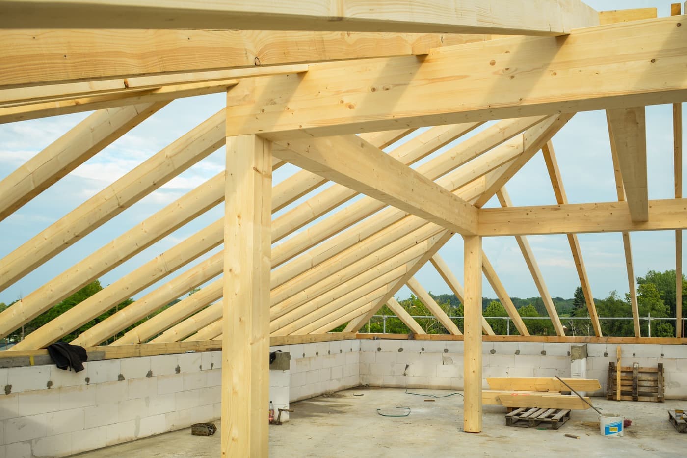 Exposed wooden roof trusses in an unfinished building