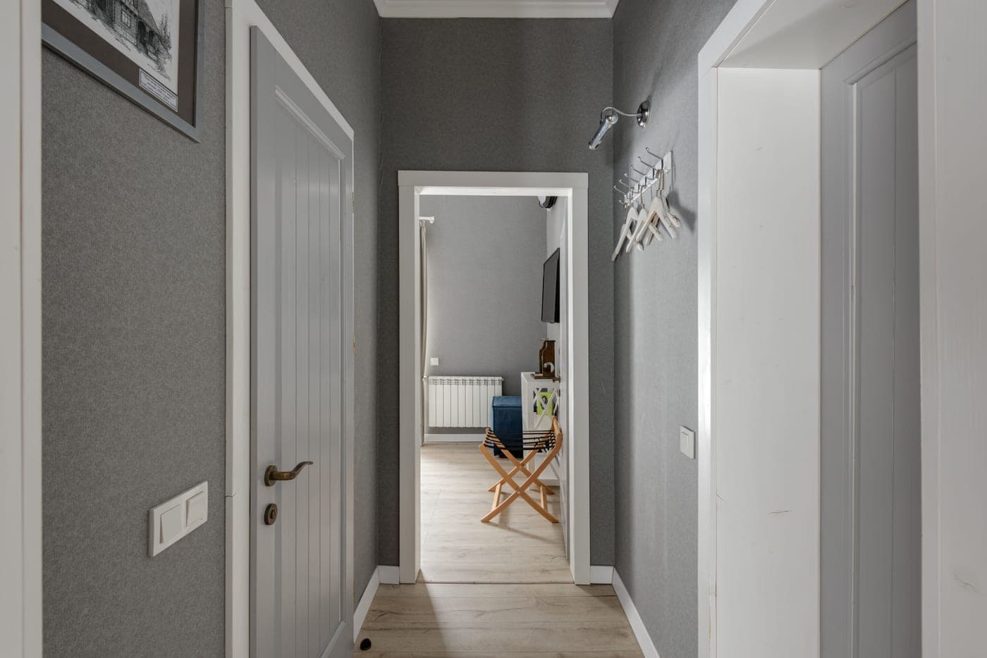 A hallway in a home with wooden doors, the kind of doorway a leverage bar hooks over