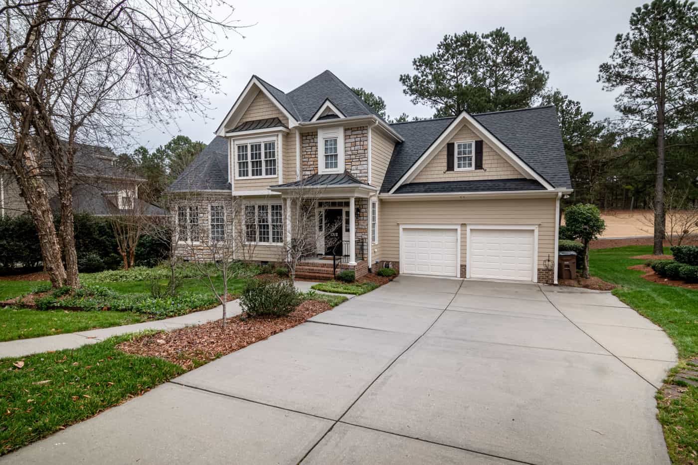 A suburban house with a two-car garage and a concrete driveway