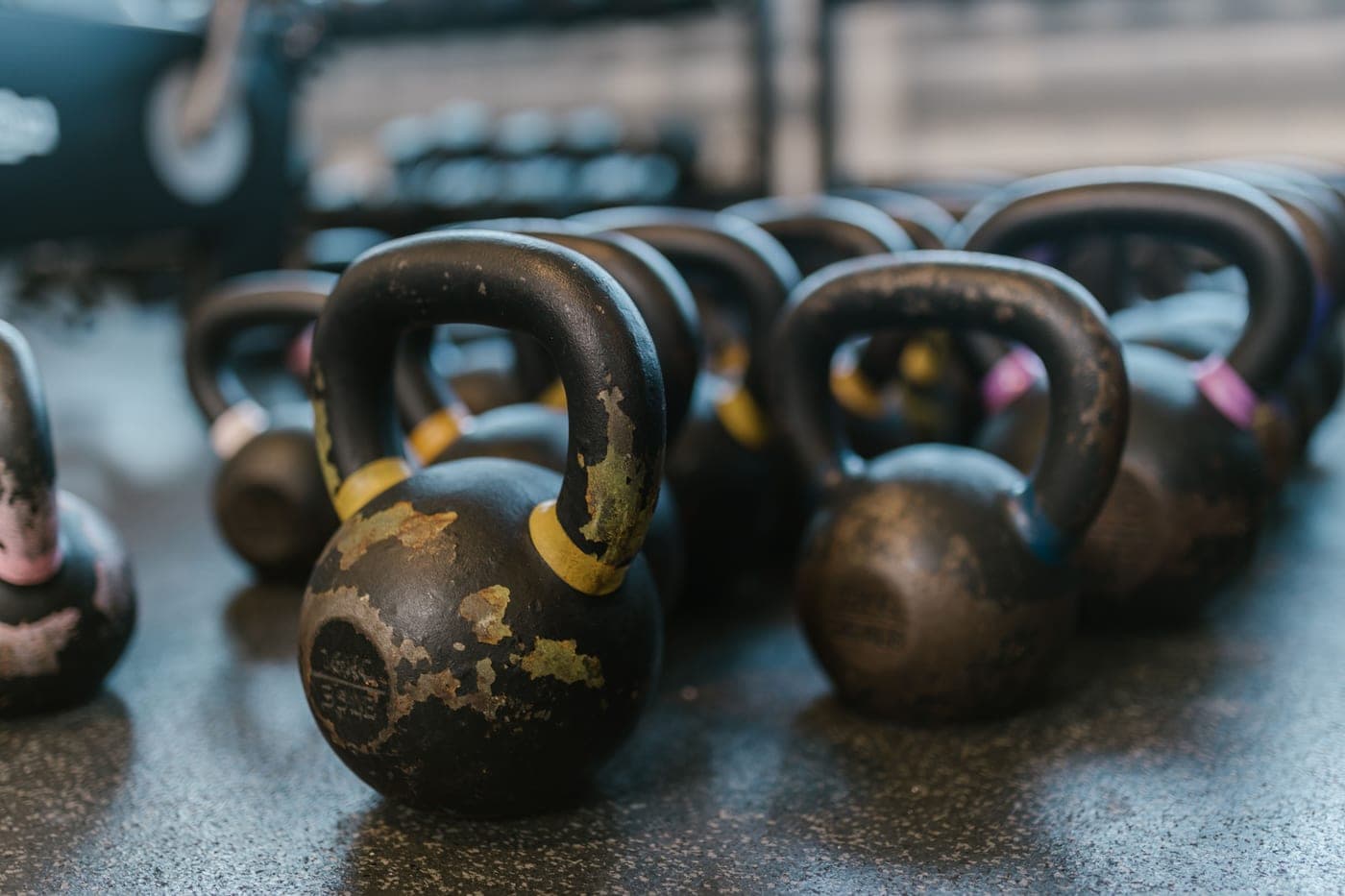 Black kettlebells on a textured gym floor