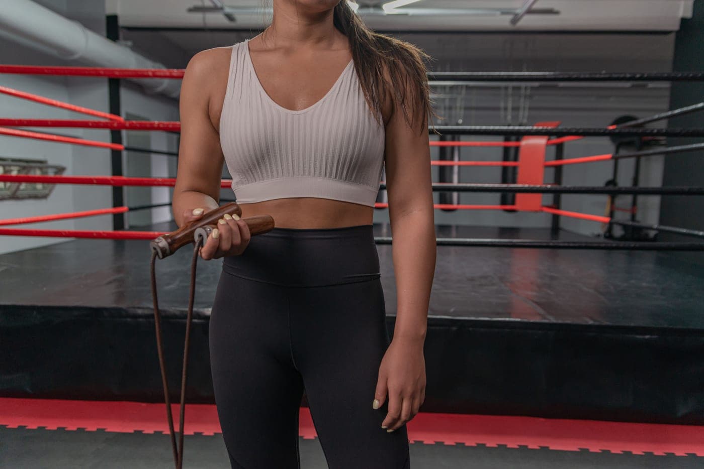 A woman holding a jump rope in a boxing gym