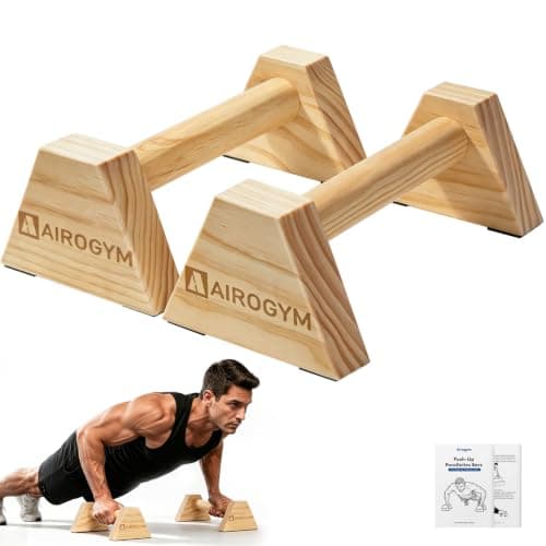 A man doing push-ups on low parallel bars in a park