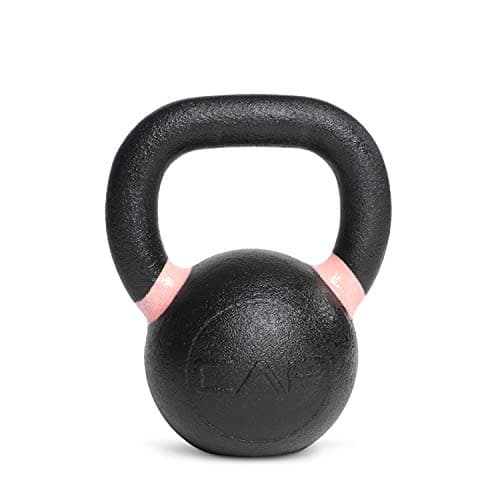 A man balancing on kettlebells at an outdoor fitness event