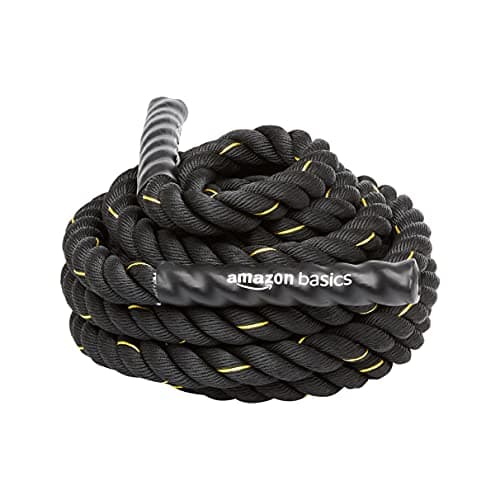 A man training with battle ropes in a gym