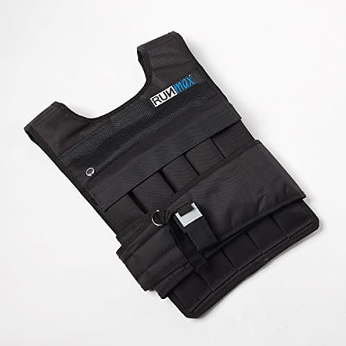 A man working out in a weighted vest in a gym