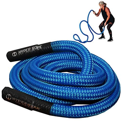 A man training with battle ropes in a gym